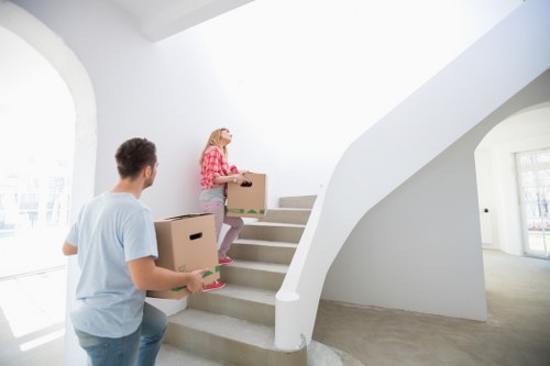 Removal team navigating stairs in a Brixton flat move