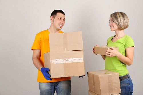 Boxes and furniture being carried in a Brixton flat move